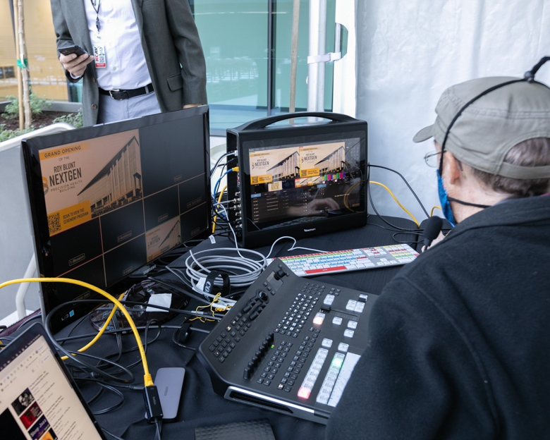 Mizzou Visual Productions staff are sitting at their control room setup for a live event.