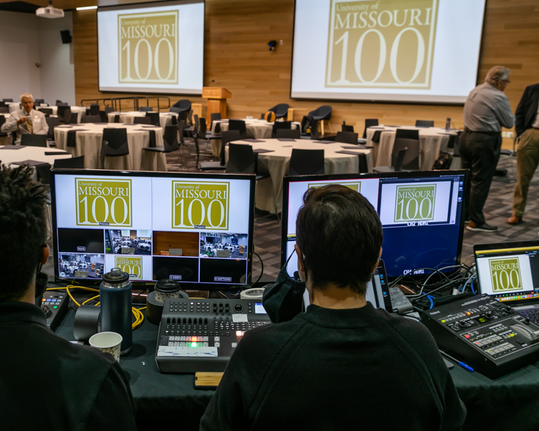 Mizzou Visual Productions staff are sitting at their control room setup for a live event.